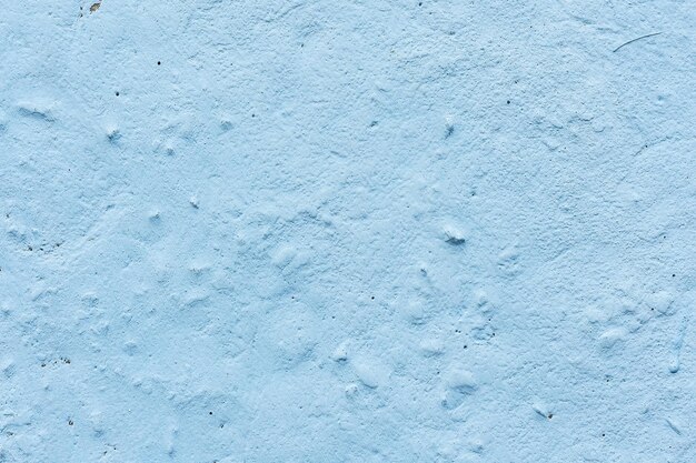 Textura de pared azul claro de hormigón Pared rugosa azul La superficie está pintada con un aerosol