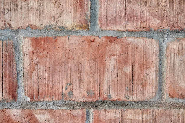 Textura de una pared de cemento de color naranja unida con cemento