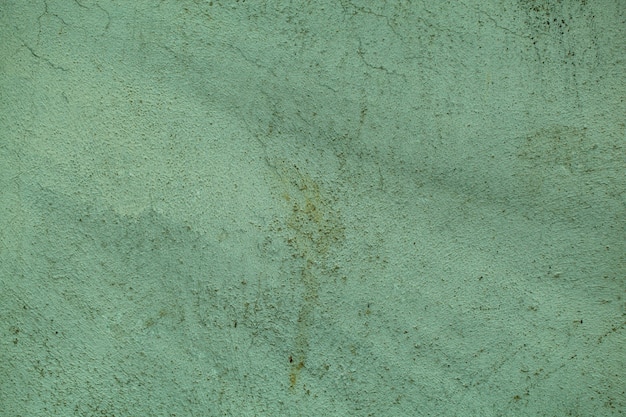 Textura de pared de cemento de estilo vintage verde sucio con pintura decolorada y grietas finas