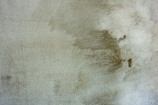 Textura, pared, fondo de hormigón. Fragmento de pared con arañazos y grietas.