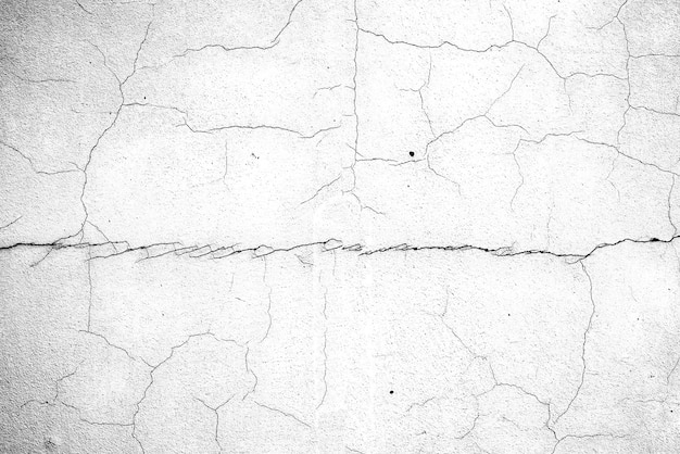 Foto textura, pared, fondo de hormigón. fragmento de pared con arañazos y grietas.