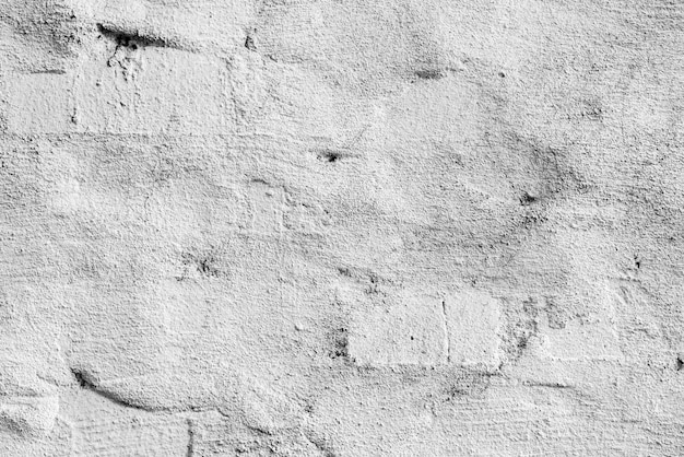 Textura, pared, fondo de hormigón. Fragmento de pared con rasguños y grietas.