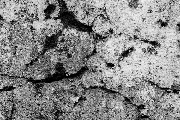 Textura, pared, fondo de hormigón. Fragmento de pared con rasguños y grietas.