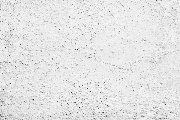 Textura, pared, hormigón. Fragmento de pared con arañazos y grietas.