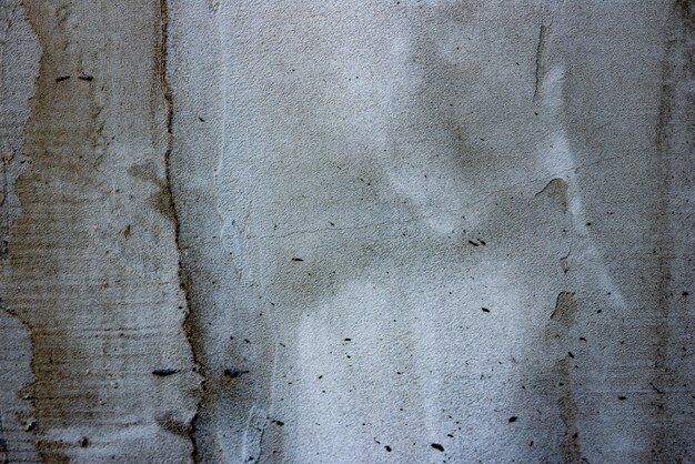 Textura, pared, hormigón, se puede utilizar como fondo. Fragmento de pared con rasguños y grietas.