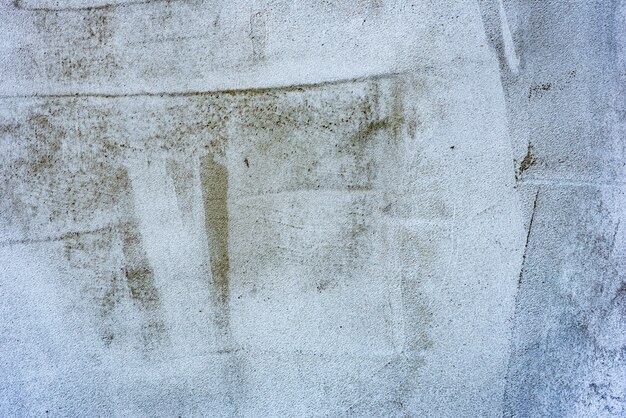 Textura, pared, hormigón, se puede utilizar como fondo. Fragmento de pared con rasguños y grietas.