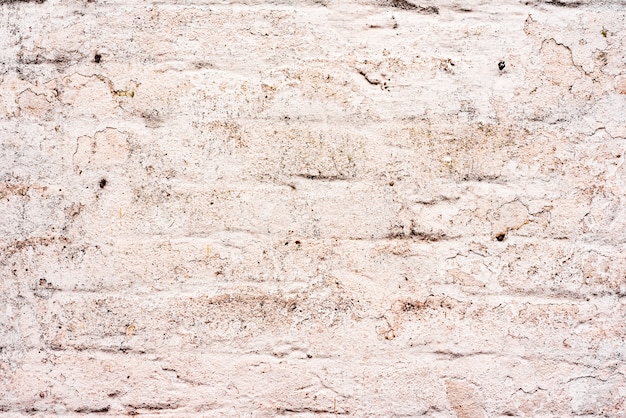 Textura de una pared de ladrillos con grietas y arañazos que se pueden utilizar como fondo