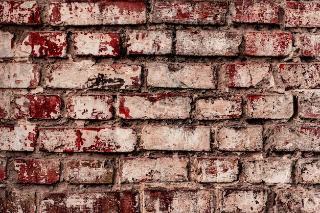 Foto textura de una pared de ladrillos con grietas y arañazos que se pueden utilizar como fondo
