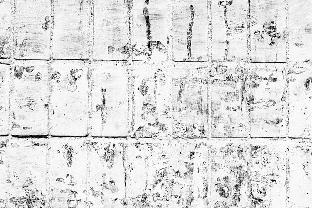 Textura de una pared de ladrillos con grietas y arañazos que se pueden utilizar como fondo