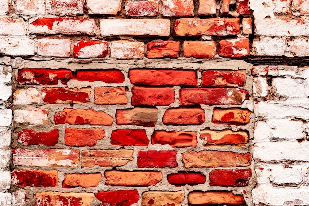 Textura de una pared de ladrillos con grietas y arañazos