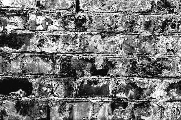 Textura de una pared de ladrillos con grietas y arañazos