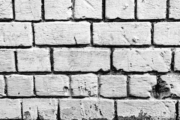 Textura de una pared de ladrillos con grietas y arañazos