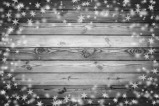 Textura de pared de madera marrón con nieve blanca y estrellas Fondo de Navidad