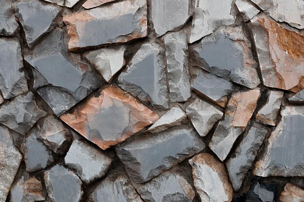 Textura de pared de piedra áspera Muro de piedra de mármol en el fondo de la calle