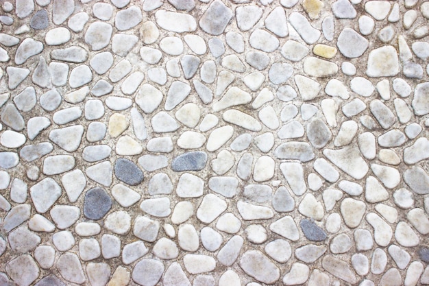 Foto textura de pared de piedra decorativa de las pequeñas rocas como fondo