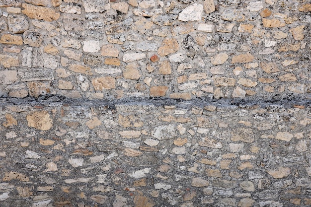 Textura de pared de piedra con muchas piedras marrones grandes