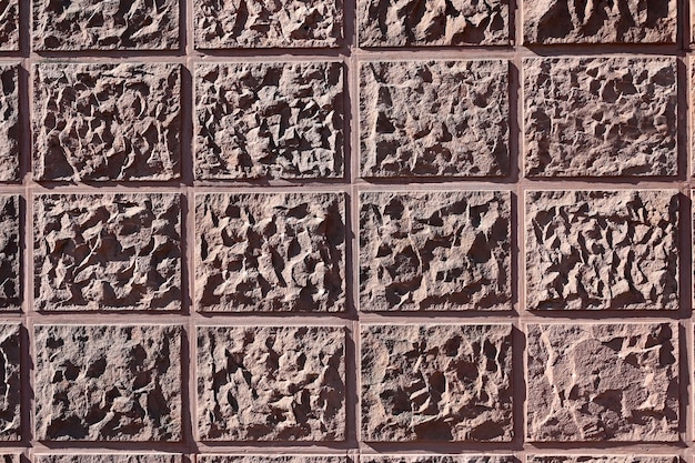 textura de una pared de relieve en un primer plano de tono rosa