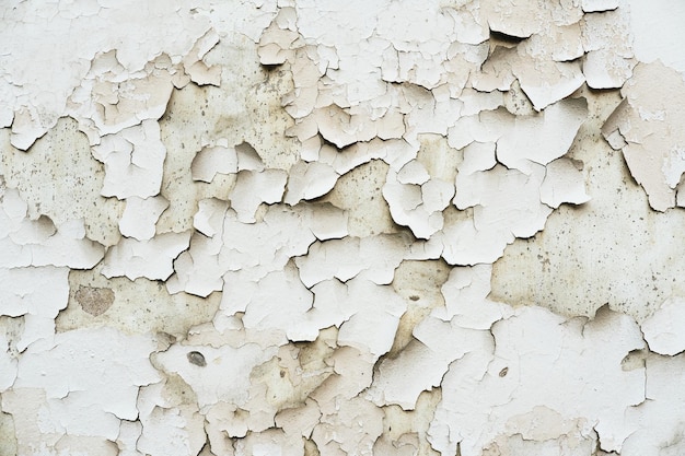 Foto textura de una pared vieja con yeso dañado y pintura rota