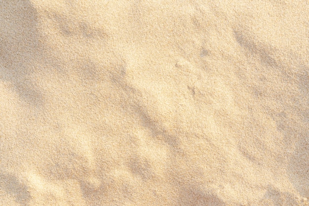 Textura de patrón de arena para el fondo. Patrón de desierto marrón de playa tropical. De cerca.