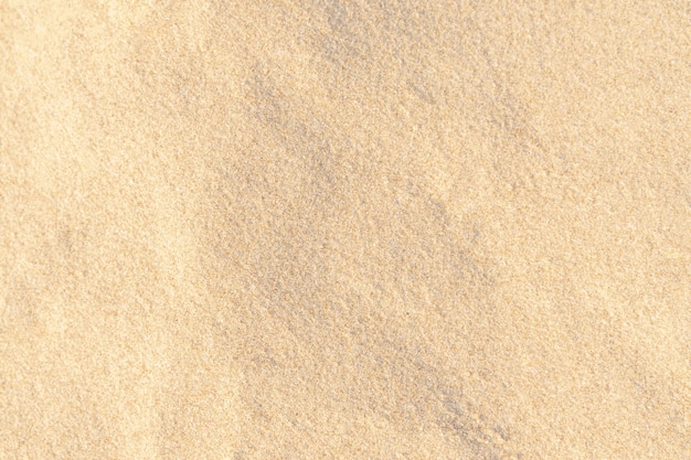 Textura de patrón de arena para el fondo. Patrón de desierto marrón de playa tropical. De cerca.