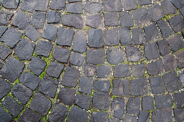 Textura de pavimento de piedra. Fondo de adoquines de granito. Extracto del primer viejo del guijarro. Sin costura . Praga