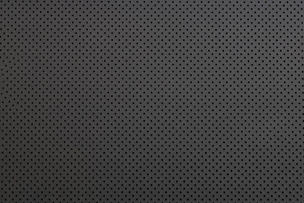Textura de una pequeña rejilla de acero negro con fondo de patrón abstracto