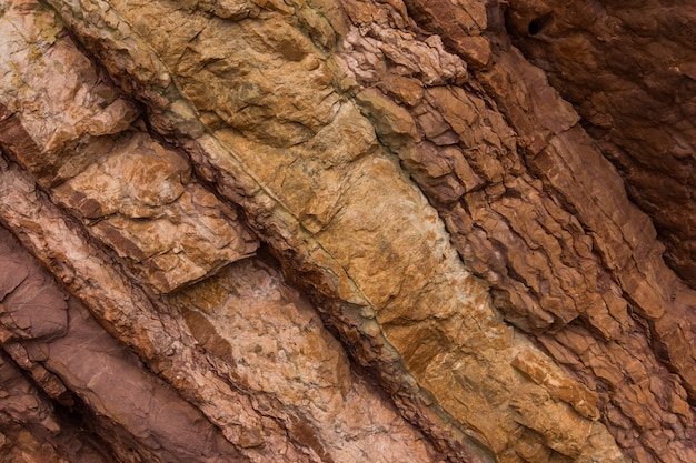 Textura de piedra de colores rojo y marrón. Fondo