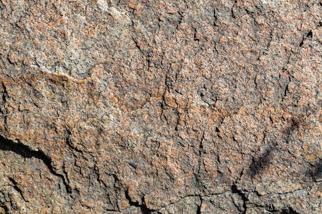 Textura de piedra de granito agrietado. Superficie de roca de granito. Telón de fondo de piedra natural. Copia espacio