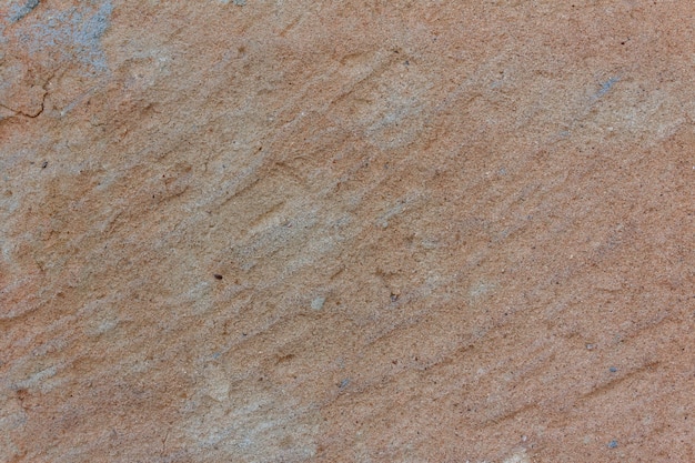 Textura de piedra pulida con detalles naranjas. Copie el espacio.