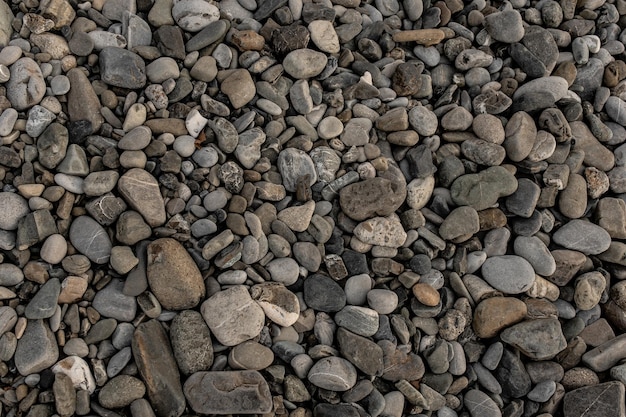 Textura de piedras de guijarros en la orilla del mar