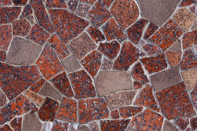 Textura plana abstracta y fondo de mosaico de piezas de granito rojo