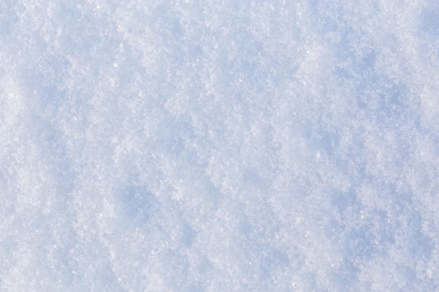 Textura plana fechada da superfície da neve à luz do dia com foco seletivo