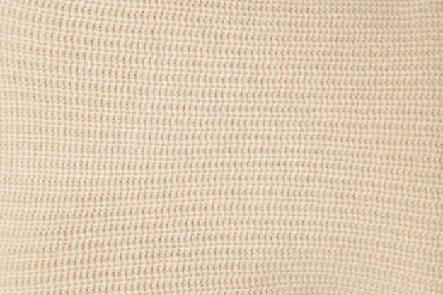 Foto textura de primer plano tejido beige lana tejida