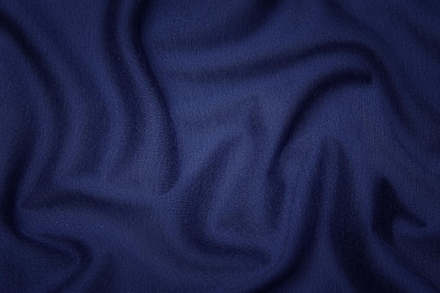 Textura de primer plano de tela azul natural o tela del mismo color. Textura de tela de algodón natural, seda o lana, o material textil de lino. Fondo de lienzo azul.