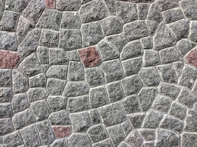 Textura revestida de piedra en la pared de diferentes formas y tonalidades para todo el marco