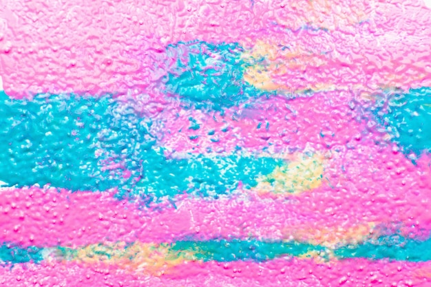 Foto textura rizada de pintura colorida mezcla espacio libre. brillante mezcla de pintura rosa, azul y amarilla. arte, creativo, diseño, cosmética, concepto de belleza