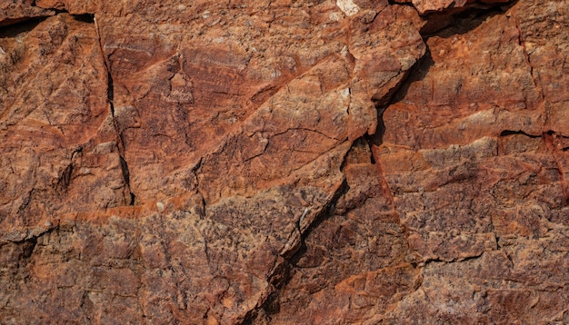 Textura de roca marrón naranja rojo oscuro con grietas