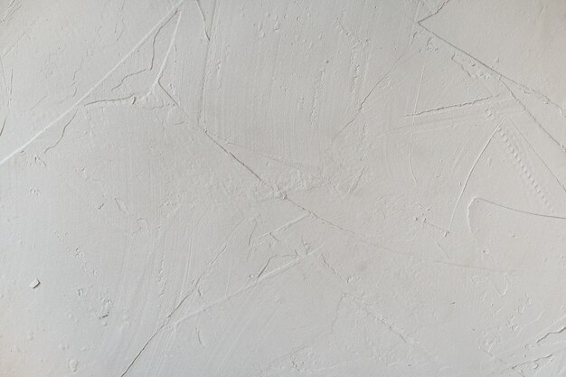 Textura rugosa desigual de la pared enlucida. Fondo abstracto, en blanco vacío