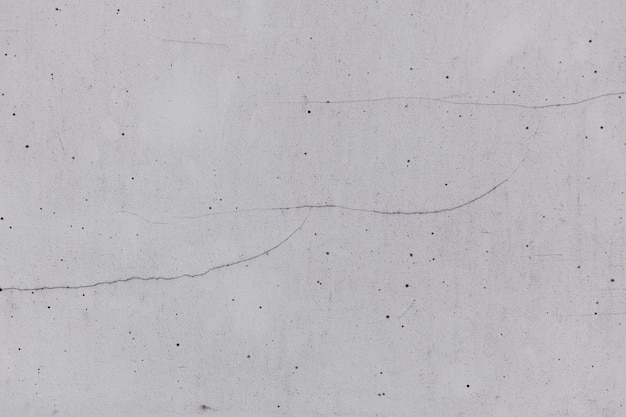 Textura rugosa del fondo gris de la pared con una grieta. fondos de pantalla para el sitio