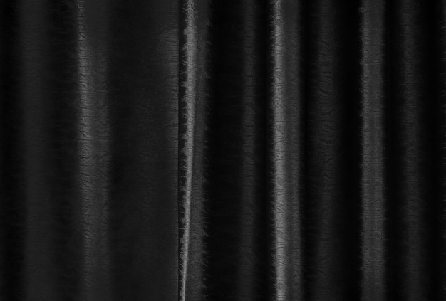 La textura de seda negra de lujo de la cortina para el fondo y el trabajo de arte del diseño.
