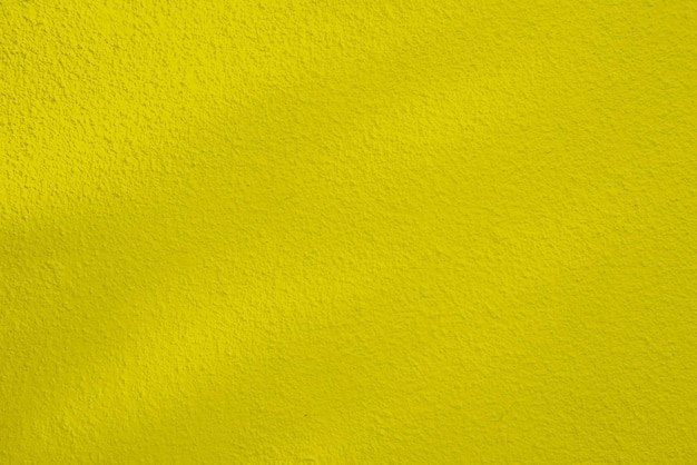 Textura sem costura da parede de cimento amarelo uma superfície áspera com espaço para texto para um fundox9