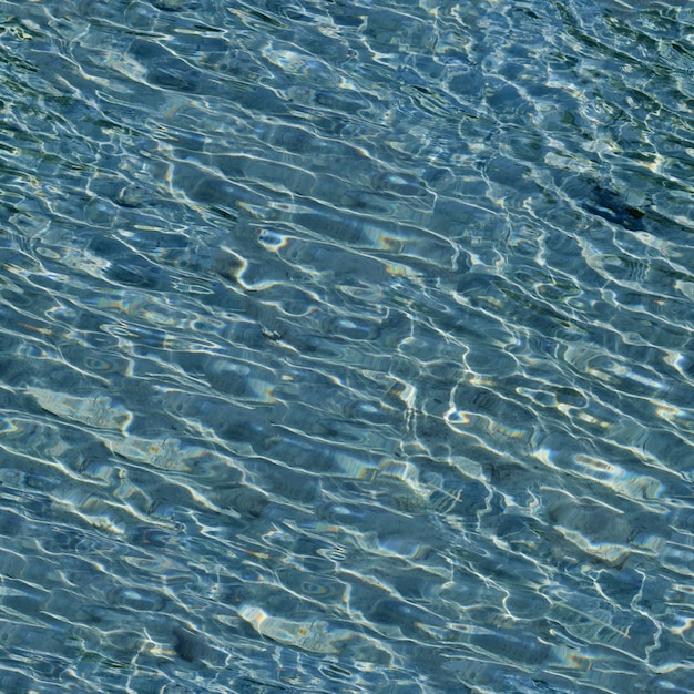 Textura sem emenda das ondas do oceano A superfície úmida limpa transparente azul do mar com ondas