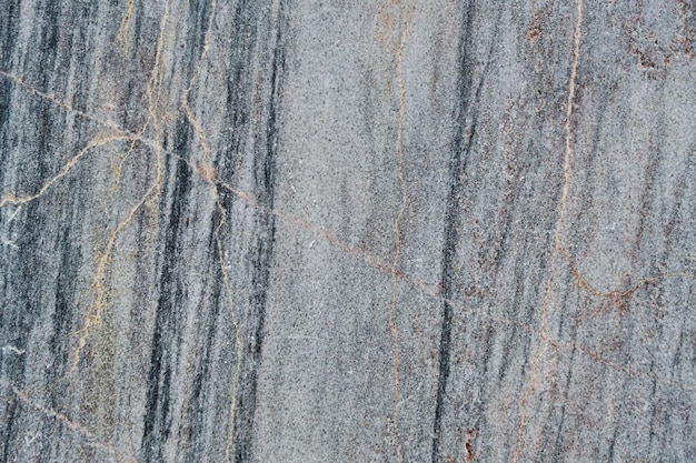 Textura y superficie de mármol de fondo con vetas rosas y grises.