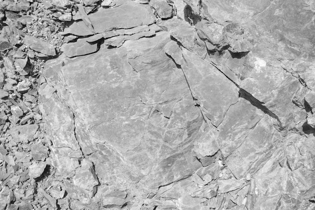 Foto textura de la superficie de la roca negra y blanca fondo de piedra erosionada