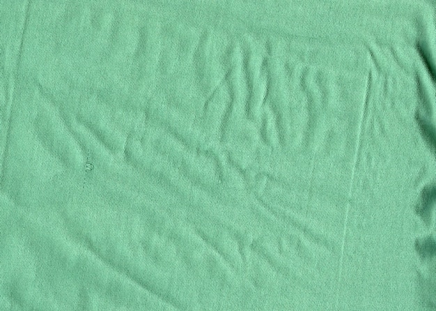 La textura de la tela de un delicado color verde con un punto fino