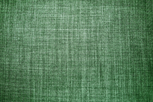 Textura de tela de fondo verde Un trozo de tela de lana está cuidadosamente dispuesto en la superficie Tejido y textura textil Tela de vestir o para la cocina necesita mantel o cortinas de cerca Guión