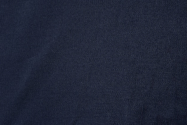 Textura de tela de lona azul oscuro. Fondo de algodón textil en blanco de fondo.