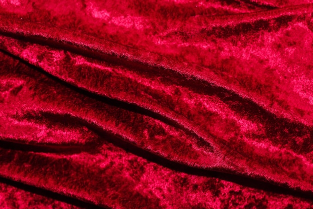 Foto textura de tela de pana de terciopelo rojo con pliegues