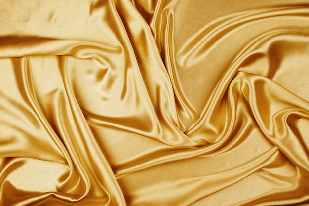 Textura de tela de satén de lujo de oro para el fondo