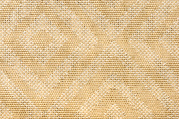 Textura de tela para tapicería de muebles en color beige con patrones rectangulares o rombos Textura de tela resistente al desgaste para la producción de muebles vista superior de primer plano